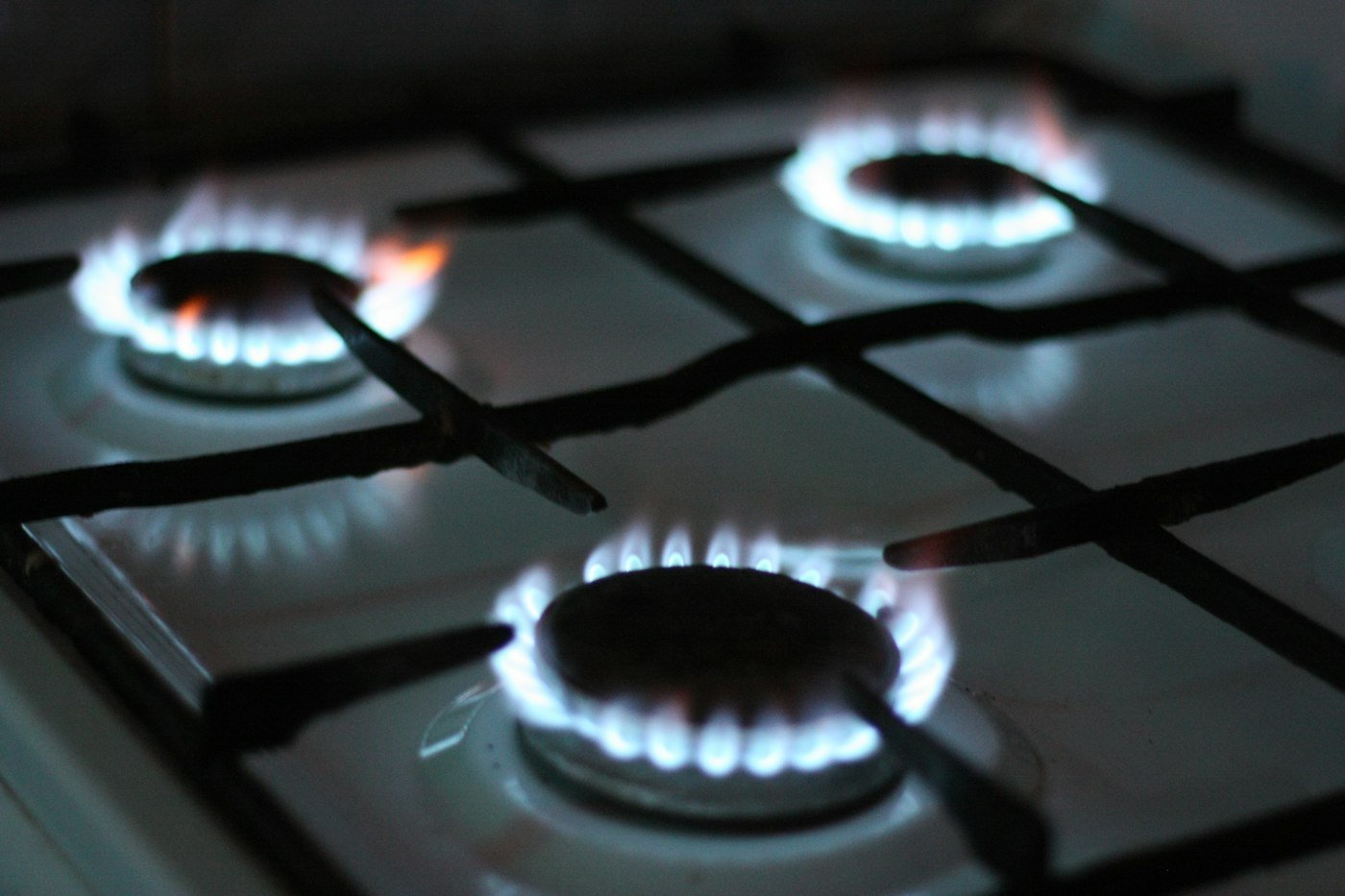 Gas hob burners lit on a clean hob